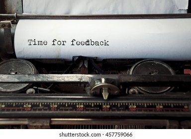 close up image of typewriter with paper sheet and the phrase: time for feedback. copy space for your text. retro filtered 