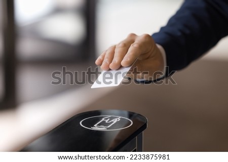 Close up image unrecognizable businessman hand using plastic pass card entering or leaving office modern workspace. Gateway and electronic card reader for area security, end or start of working day