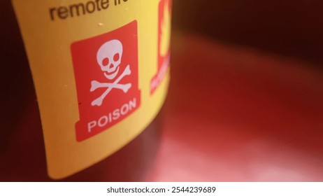 close up image of a warning sign on a bottle label with poison label, dangerous liquid, harmful to consume, poison warning