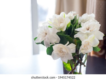 Close Up Image Of White Gardenia Bouquet In The Vast Put On The Table In The Room.