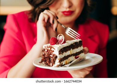 Close Up Image Of Woman Eating Cake Black Forest Decorated With White Chocolate And Raspeberries