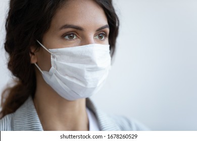 Close up image woman in facial medical mask on blue background, concept of protection to globally spread pandemic infection disease coronavirus or COVID-19 illness that affect your lungs and airways