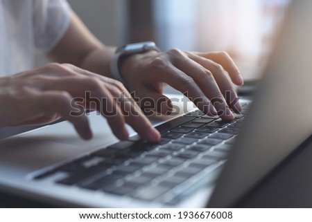 Close up image of woman hands typing on laptop computer keyboard and surfing the internet on office table, online, working, business and technology, internet network communication concept
