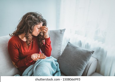 Close up image woman holding round pill and glass of still water taking painkiller to relieve painful feelings migraine headache, antidepressant or antibiotic medication, emergency treatment concept - Shutterstock ID 1508066993