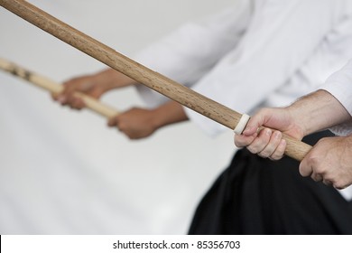 Close up image of wooden swords (bokken) held by Japanese swordmanship practitioners. - Powered by Shutterstock