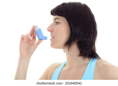 Close up image of a young woman using inhaler for asthma. White background studio picture