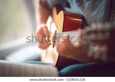 Close up images of girl playing guitar 