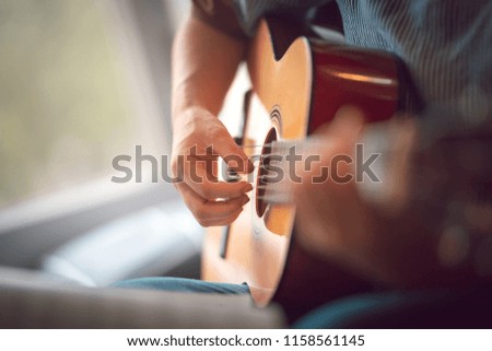 Close up images of girl playing guitar 