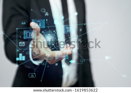 Close up of incognito businessman in suit standing in office. Selective focus of virtual projection of digital tactile charts screen, man holding in hand. Concept of high technologies, digitalization.