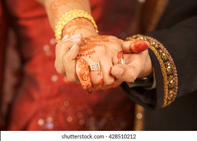 Close up of Indian couple's hands at a wedding