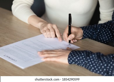 Close Up Indian Woman Client Signing Contract, Making Deal With Realtor Broker, Manager Pointing Finger On Place For Signature, Hr Recruiter Hiring New Employee After Successful Job Interview