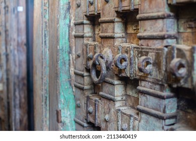 Close Up Indian Wooden Old Door Vintage Texture Background. Ancient Mughal Art Door Doors Made Of Authentic Material In An Old Building Entrance. Weathered Wood Carved Door In India. Selective Focus.