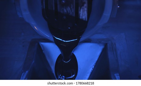 Close Up Of Industrial Automated Mixing Machine Pouring Black Resin At Industrial Plant. Manufacturing Of Plastic. Cnc Machine Processing Melted Resin