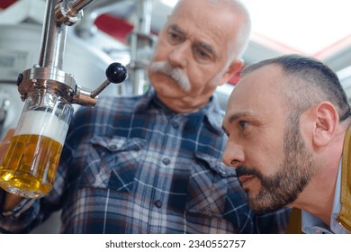 close up of industrial beer brewing worker - Powered by Shutterstock