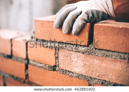 Close up of industrial bricklayer installing bricks on construction site ストックフォト © 