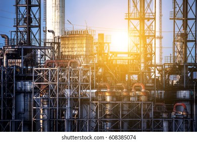 Close up industrial view oil and gas refinery area with sunset and cloudy sky background