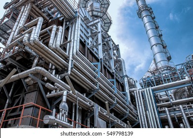 Close Up Industrial View At Oil Refinery Plant Form Industry Zone With Sunrise And Cloudy Sky