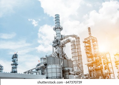 Close Up Industrial View At Oil Refinery Plant Form Industry Zone With Blue Sky And Sunrise Sky Background