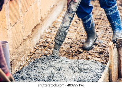 close up of industrial worker pouring cement or concrete with automatic pump tube