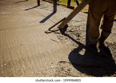 Close up of industrial worker smoothes cement or concrete