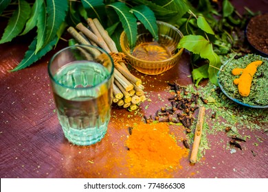 Close Up Of Ingredients Of Ayurvedic Treatment I.e Neem,neem Leaves,neem Powder,bark,clove,turmeric,water.