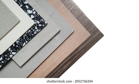 close up interior construction material samples containing grainy artificial stone, black terrazzo, grey marble tile, oak and walnut wooden laminateds isolated on white background with clipping path.