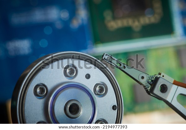 Close up interior of hard disk. Open cover hard disk\
in computer or server. Technology background. Selective focus to\
hdd read - write head