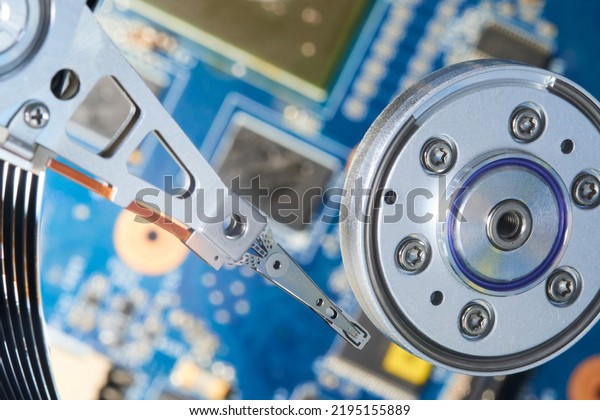 Close up interior of hard disk. Open cover hard disk\
in computer or server. Technology background. Selective focus to\
hdd read - write head