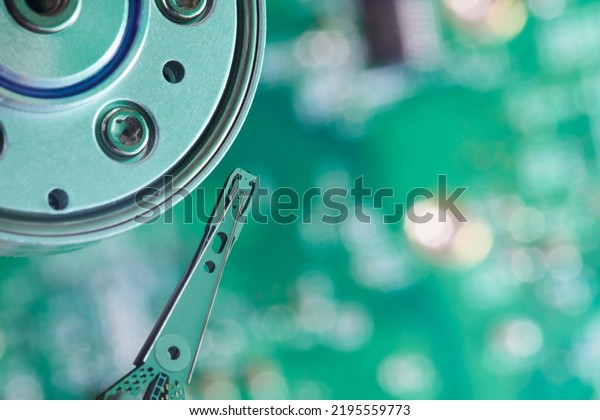 Close up interior of hard\
disk. Open cover hard disk in computer or server. Technology\
background. Selective focus to hdd read - write head. Data Backup\
concept. 