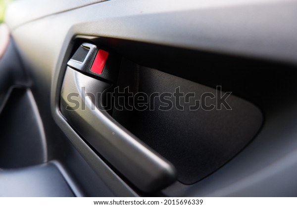 Close up interior view of the car system.  Inner\
car door handle