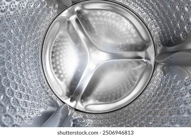 Close up internal view of an empty washing machine drum during wash