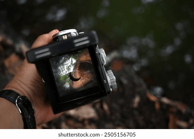 Close up into the frame of classical twin lens reflect camera viewfinder, showing the ancient brick bridge of ancient ayutthaya kingdom.