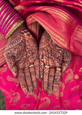 Close up of an intricately design henna or Mehendi on the lady's palm. A sari clad woman showing off beautiful Mehandi design in the wedding.