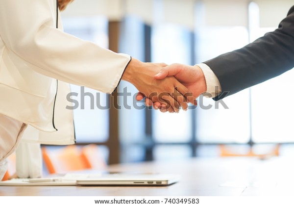 close up investor businessman handshake with\
partner vendor after completed acquisition ,collaboration of two\
ceo leader hand shake for make agreement or deal financial\
cooperative and synergy\
concept