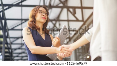 
close up investor businesswoman handshake with partner vendor,collaboration of two ceo leader hand shake for agreement or b2b deal financial cooperative concept