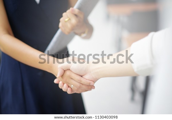 close up investor\
businesswoman handshake with partner vendor,collaboration of two\
ceo leader hand shake for agreement or deal financial cooperative\
concept.
