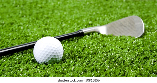 Close Up Of Iron Golf Club On Green Grass(artificial Turf) At Low Angle