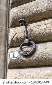 Close up of an iron ring (or hitching post) used in ancient times to tie horses and to hold fire lamps, on a wall of a medieval building in Florence city center, Tuscany region, Italy