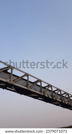 Close up of iron water pipe with protective iron frame with sky background