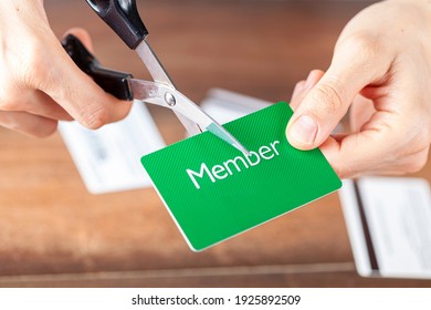 Close up isolated image of A young woman cutting a membership card. Customizable with copy space on the card. Suitable for cutting the costs, cancellation, termination of subscription and membership
