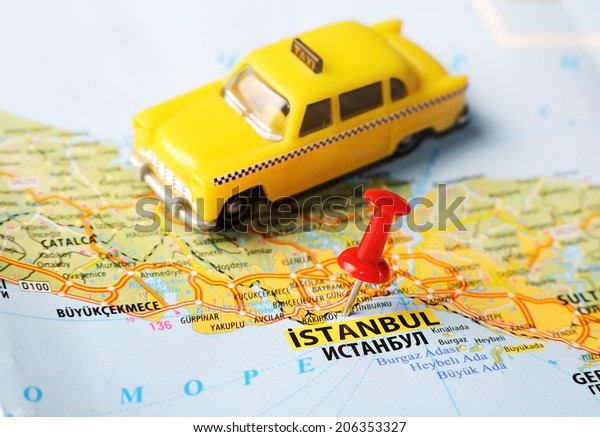 Close up of  Istanbul ,Turkey  map with red pin \
and a taxi  - Travel\
concept