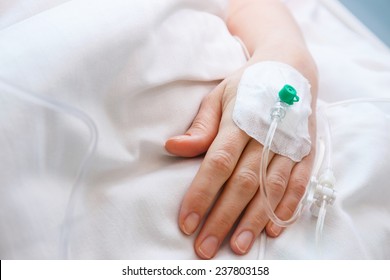 Close Up Of A Iv Drip In Patient's Hand