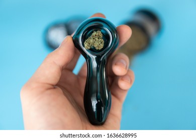 Close up of Jack Herrer medical marijuana bud in grinder on blue Background