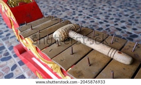 Close up of Javanese traditional percussive instrument called demung. Indonesia musical instrument called gamelan with mallet above.