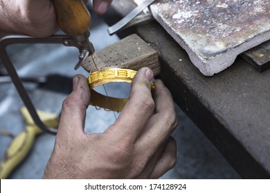 Close up of Jeweler crafting golden bangle with flame torch. - Powered by Shutterstock