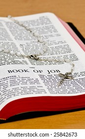 Close Up Of Job Bible Page With Rosary