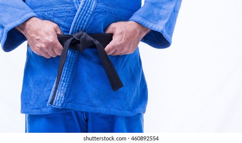 Close up of judo judo-gi whit belt isolated on white background