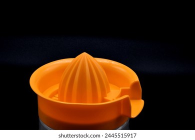 Close up of a juicer with a black background - Powered by Shutterstock