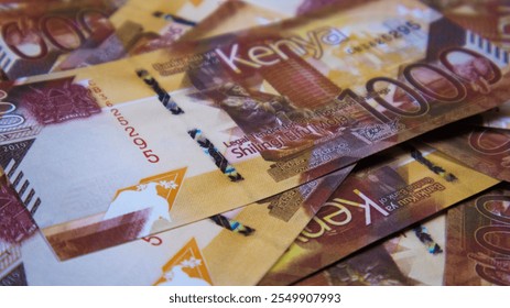 close up of Kenyan shilling notes spread on table. Paper money currency scattered on surface as background