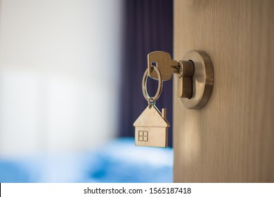 close up key on the door with morning light, personal loan concept. subject is blurry. - Shutterstock ID 1565187418